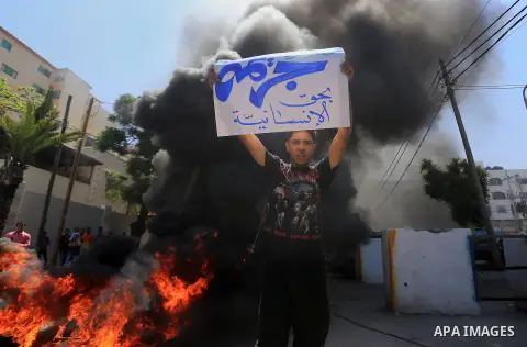 Palestinian owners of houses which were destroyed during the recent Israeli war, burn tires during a protest, in front of high commissioner for human rights headquarters, in Gaza City on April 20, 2016. Israeli occupatio...