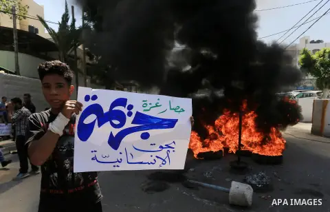 Palestinian owners of houses which were destroyed during the recent Israeli war, burn tires during a protest, in front of high commissioner for human rights headquarters, in Gaza City on April 20, 2016. Israeli occupatio...