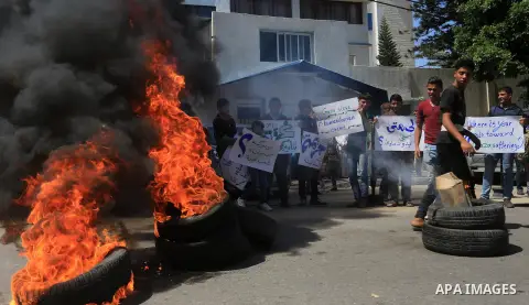 Palestinian owners of houses which were destroyed during the recent Israeli war, burn tires during a protest, in front of high commissioner for human rights headquarters, in Gaza City on April 20, 2016. Israeli occupatio...