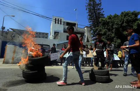 Palestinian owners of houses which were destroyed during the recent Israeli war, burn tires during a protest, in front of high commissioner for human rights headquarters, in Gaza City on April 20, 2016. Israeli occupatio...
