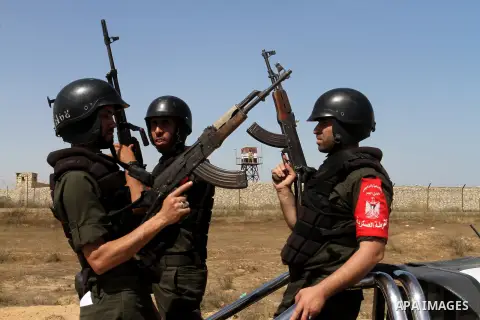 Members of Palestinian security forces loyal to Hamas ride a pickup truck as they are deployed to maintain security on the border of southern Gaza Strip with Egypt, April 21, 2016. Hamas began deploying additional forces...