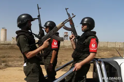 Members of Palestinian security forces loyal to Hamas ride a pickup truck as they are deployed to maintain security on the border of southern Gaza Strip with Egypt, April 21, 2016. Hamas began deploying additional forces...