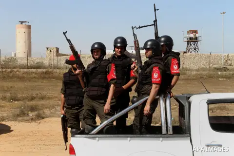 Members of Palestinian security forces loyal to Hamas ride a pickup truck as they are deployed to maintain security on the border of southern Gaza Strip with Egypt, April 21, 2016. Hamas began deploying additional forces...
