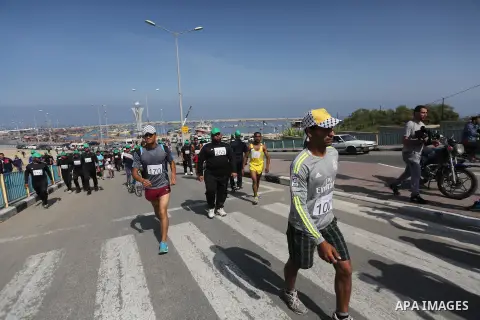 Palestinian youths take part in a marathon organized by Hamas and Fateh movement to mark Palestinian Prisoner Day, in Gaza city, on April 23, 2016. Photo by Mohammed Asad