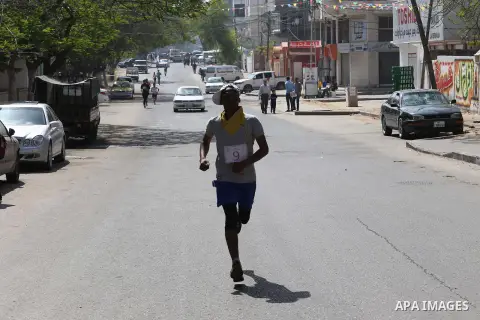 Palestinian youths take part in a marathon organized by Hamas and Fateh movement to mark Palestinian Prisoner Day, in Gaza city, on April 23, 2016. Photo by Mohammed Asad