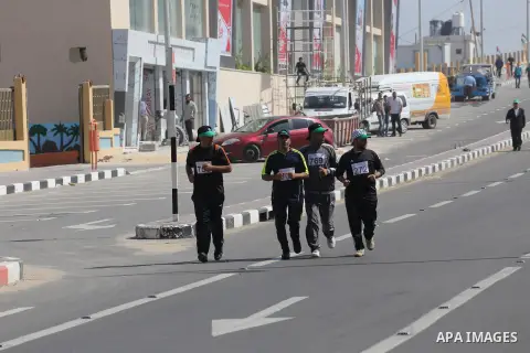 Palestinian youths take part in a marathon organized by Hamas and Fateh movement to mark Palestinian Prisoner Day, in Gaza city, on April 23, 2016. Photo by Mohammed Asad