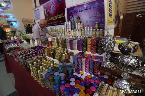 Palestinians attend exhibition for national products at Islamic University, in Gaza city, on April 24, 2016. Photo by Mohammed Asad