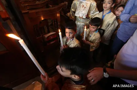 Palestinian Christians take part in the Greek Orthodox Christian Palm Sunday celebrations at St.Porphyrios Church in Gaza City, on April 24, 2016. Palm Sunday marks the triumphant return of Jesus Christ to Jerusalem when...