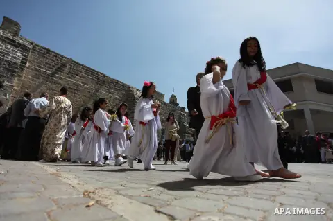 Palestinian Christians take part in the Greek Orthodox Christian Palm Sunday celebrations at St.Porphyrios Church in Gaza City, on April 24, 2016. Palm Sunday marks the triumphant return of Jesus Christ to Jerusalem when...