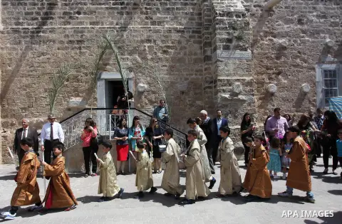 Palestinian Christians take part in the Greek Orthodox Christian Palm Sunday celebrations at St.Porphyrios Church in Gaza City, on April 24, 2016. Palm Sunday marks the triumphant return of Jesus Christ to Jerusalem when...