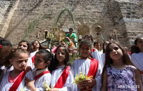 Palestinian Christians take part in the Greek Orthodox Christian Palm Sunday celebrations at St.Porphyrios Church in Gaza City, on April 24, 2016. Palm Sunday marks the triumphant return of Jesus Christ to Jerusalem when...