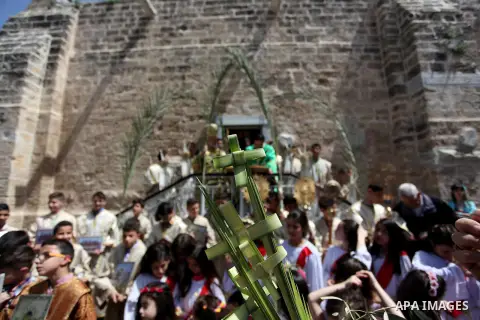 Palestinian Christians take part in the Greek Orthodox Christian Palm Sunday celebrations at St.Porphyrios Church in Gaza City, on April 24, 2016. Palm Sunday marks the triumphant return of Jesus Christ to Jerusalem when...