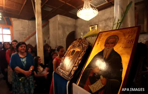 Palestinian Christians take part in the Greek Orthodox Christian Palm Sunday celebrations at St.Porphyrios Church in Gaza City, on April 24, 2016. Palm Sunday marks the triumphant return of Jesus Christ to Jerusalem when...