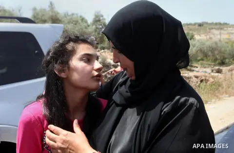 Released Palestinian prisoner Deema Al-Wawi, 12, who was detained by Israeli authorities for around two and half months, hugs her mother following her release near the West Bank city of Tulkarm April 24, 2016. Photo by N...