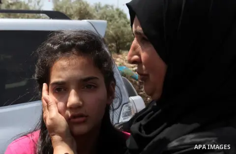 Released Palestinian prisoner Deema Al-Wawi, 12, who was detained by Israeli authorities for around two and half months, hugs her mother following her release near the West Bank city of Tulkarm April 24, 2016. Photo by N...