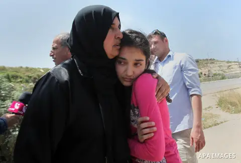 Released Palestinian prisoner Deema Al-Wawi, 12, who was detained by Israeli authorities for around two and half months, hugs her mother following her release near the West Bank city of Tulkarm April 24, 2016. Photo by N...