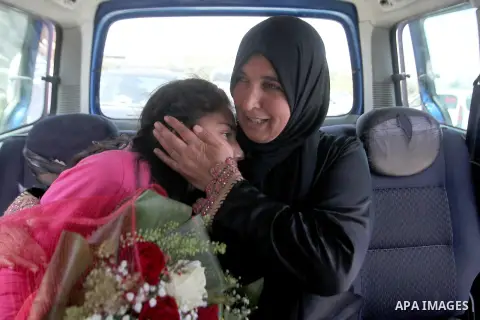 Released Palestinian prisoner Deema Al-Wawi, 12, who was detained by Israeli authorities for around two and half months, sits with her mother in a vehicle following her release near the West Bank city of Tulkarm April 24...