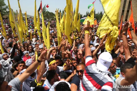 Palestinian students supporting Fatah movement take part in a rally during an election campaign for the student council at the Birzeit University in the West Bank city of Ramallah April 26, 2016. Photo by Shadi Hatem