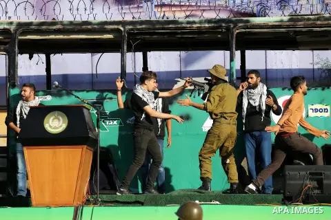 A mock burnt Israeli bus is seen on a stage during an anti-Israel rally organised by the Palestinian Hamas movement in Gaza city April 28, 2016. Photo by Mohammed Asad