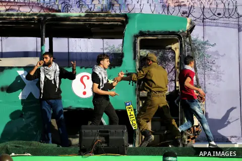 A mock burnt Israeli bus is seen on a stage during an anti-Israel rally organised by the Palestinian Hamas movement in Gaza city April 28, 2016. Photo by Mohammed Asad