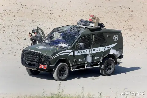 Israeli border guards hold a position during clashes with Palestinian stone throwers on April 29, 2016, following a demonstration in solidarity with Palestinian prisoners held in Israeli jails, outside the compound of th...