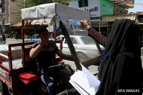 Palestinian women supporting Hamas movement distribute posters during awareness campaign against collaborate with Israel, in Rafah in southern Gaza strip, on April 30, 2016. Photo by Abed Rahim Khatib