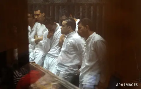 Egyptian defendants wait behind bars for the verdict in their retrial over a 2012 stadium riot in the canal city of Port Said at the police academy on the outskirts of the capital Cairo on April 30, 2016. Seven defendant...