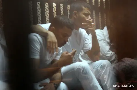 Egyptian defendants wait behind bars for the verdict in their retrial over a 2012 stadium riot in the canal city of Port Said at the police academy on the outskirts of the capital Cairo on April 30, 2016. Seven defendant...