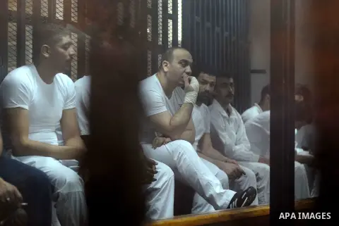 Egyptian defendants wait behind bars for the verdict in their retrial over a 2012 stadium riot in the canal city of Port Said at the police academy on the outskirts of the capital Cairo on April 30, 2016. Seven defendant...