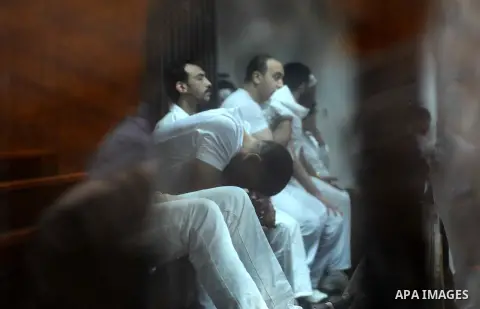 Egyptian defendants wait behind bars for the verdict in their retrial over a 2012 stadium riot in the canal city of Port Said at the police academy on the outskirts of the capital Cairo on April 30, 2016. Seven defendant...