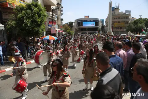 Palestinian christians march in the traditional Sabt al-Nour parade, in the West Bank city of Ramallah, on April 30, 2016. The Holy Fire is described by Orthodox Christians as a miracle that occurs every year at the Chur...