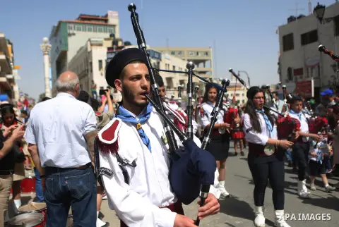 Palestinian christians march in the traditional Sabt al-Nour parade, in the West Bank city of Ramallah, on April 30, 2016. The Holy Fire is described by Orthodox Christians as a miracle that occurs every year at the Chur...
