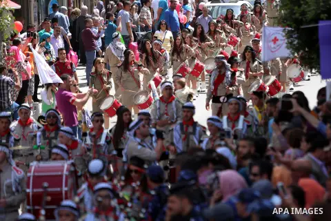 Palestinian christians march in the traditional Sabt al-Nour parade, in the West Bank city of Ramallah, on April 30, 2016. The Holy Fire is described by Orthodox Christians as a miracle that occurs every year at the Chur...