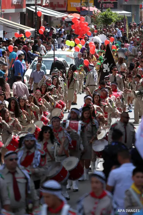 Palestinian christians march in the traditional Sabt al-Nour parade, in the West Bank city of Ramallah, on April 30, 2016. The Holy Fire is described by Orthodox Christians as a miracle that occurs every year at the Chur...