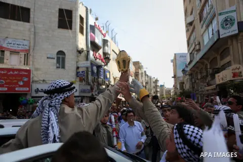 Palestinian christians march in the traditional Sabt al-Nour parade, in the West Bank city of Ramallah, on April 30, 2016. The Holy Fire is described by Orthodox Christians as a miracle that occurs every year at the Chur...
