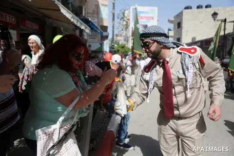 Palestinian christians march in the traditional Sabt al-Nour parade, in the West Bank city of Ramallah, on April 30, 2016. The Holy Fire is described by Orthodox Christians as a miracle that occurs every year at the Chur...