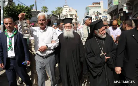 Palestinian christians march in the traditional Sabt al-Nour parade, in the West Bank city of Ramallah, on April 30, 2016. The Holy Fire is described by Orthodox Christians as a miracle that occurs every year at the Chur...