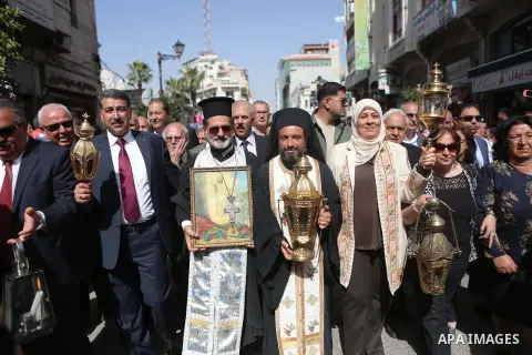 Palestinian christians march in the traditional Sabt al-Nour parade, in the West Bank city of Ramallah, on April 30, 2016. The Holy Fire is described by Orthodox Christians as a miracle that occurs every year at the Chur...