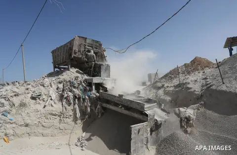 Palestinian workers crush stones and cement blocks from houses destroyed by Israeli shelling during the 50-day Israeli war in the summer of 2014, during the Workers' Day, in Gaza city, on May, 1, 2016. Photo by Mohammed...