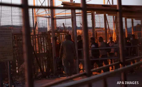 Palestinian labourers working in Israel wait to cross a checkpoint to go to work through the main Israeli terminal near the West Bank town of Qalqilya on International Workers' Day May 1, 2016. Photo by Stringer