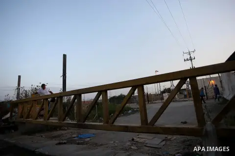 Palestinian labourers working in Israel wait to cross a checkpoint to go to work through the main Israeli terminal near the West Bank town of Qalqilya on International Workers' Day May 1, 2016. Photo by Stringer