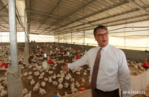 Representative for the Netherlands to the Palestinian Authority Peter Mollema gestures as he visits a chicken farm supplied with water that is provided by a Dutch-funded project, in Khan Younis in the southern Gaza Strip...