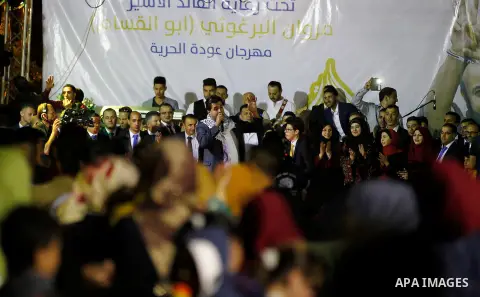 Palestinians take part in a opening ceremony of al-Hurria radio broadcasting office after the closure by the Israeli military, in the West Bank city of Hebron, on May 1, 2016. Photo by Wisam Hashlamoun