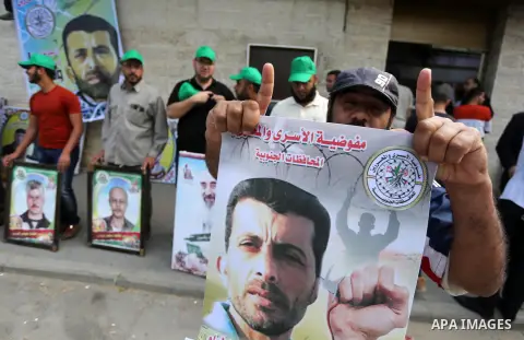 Palestinians take part in a protest demanding release the prisoners in Israeli jails, in front of Red cross office, in Gaza city, on May 2, 2016. Photo by Mohammed Asad