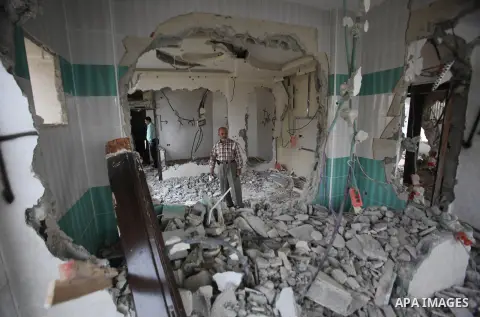 Palestinians look at the damage in the West Bank city of Nablus on May 3, 2016, after Israeli forces destroyed the house of Zaid Amer, a Palestinian man accused of taking part in the killing of a Jewish settler couple ne...
