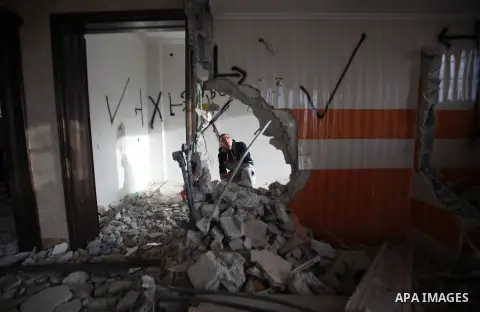 Palestinians look at the damage in the West Bank city of Nablus on May 3, 2016, after Israeli forces destroyed the house of Zaid Amer, a Palestinian man accused of taking part in the killing of a Jewish settler couple ne...