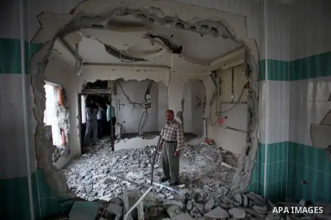 Palestinians look at the damage in the West Bank city of Nablus on May 3, 2016, after Israeli forces destroyed the house of Zaid Amer, a Palestinian man accused of taking part in the killing of a Jewish settler couple ne...