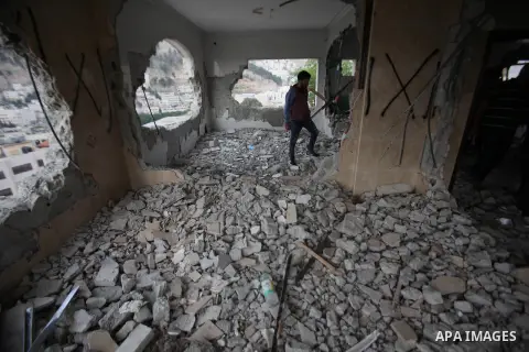Palestinians look at the damage in the West Bank city of Nablus on May 3, 2016, after Israeli forces destroyed the house of Zaid Amer, a Palestinian man accused of taking part in the killing of a Jewish settler couple ne...
