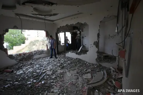 Palestinians look at the damage in the West Bank city of Nablus on May 3, 2016, after Israeli forces destroyed the house of Zaid Amer, a Palestinian man accused of taking part in the killing of a Jewish settler couple ne...