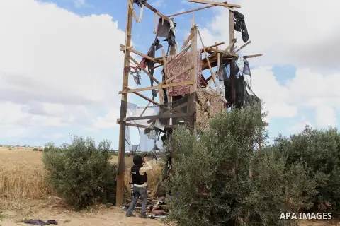 A picture taken on May 7, 2016 show a watch-tower of the Ezzedine al-Qassam Brigades, the armed wing of the Hamas movement, near Rafah in the southern Gaza Strip on the border with Israel, after it was damaged following...